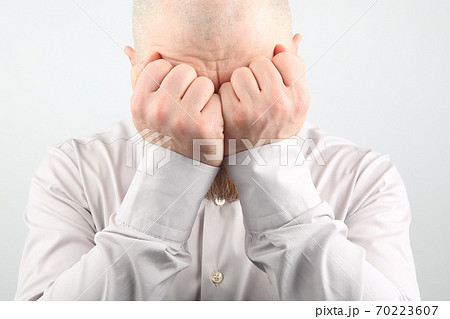 sad man with hands closed face on white background sad man with hands closed face on white background 70223607