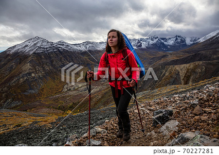 Girl Backpacking along Scenic Hiking Trail Girl Backpacking along Scenic Hiking Trail 70227281