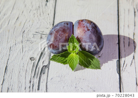 Trendy ugly organic fruit purple plum on the wooden background. 70228043