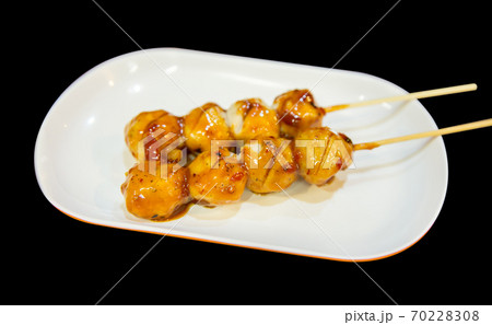 Grilled meatballs or pork on skewers with chili sauce in white plate, focus selective 70228308