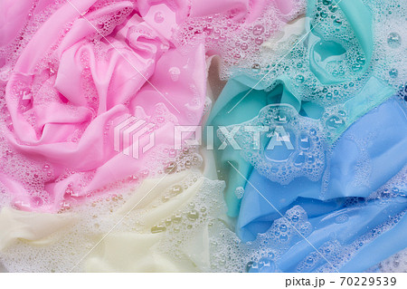 Color clothes soak in powder detergent water dissolution. Laundry concept Color clothes soak in powder detergent water dissolution. Laundry concept 70229539