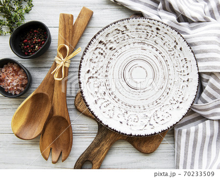 Empty plate on a wooden table Empty plate on a wooden table 70233509