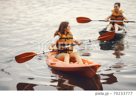 Women paddling on a lake in a kayak 70233777