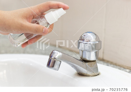 Women's hands are injecting 70% alcohol killing bacteria and the coronal virus or covid-19 to prevent germs, Inhibition of Covid-19 Virus Infection concept. 70235776