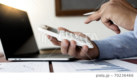 Businessmen analyze market data and calculate the cost of buying-selling products for a client's company, Professional marketing and financial accountants concept. 70236466