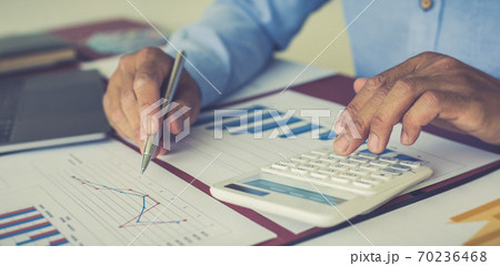 Businessmen analyze market data and calculate the cost of buying-selling products for a client's company, Professional marketing and financial accountants concept. 70236468