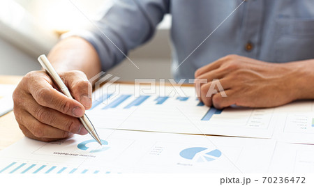 Businessmen analyze market data and calculate the cost of buying-selling products for a client's company, Professional marketing and financial accountants concept. 70236472