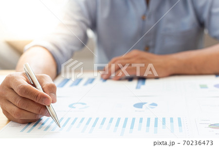 Businessmen analyze market data and calculate the cost of buying-selling products for a client's company, Professional marketing and financial accountants concept. 70236473
