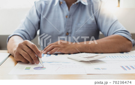 Businessmen analyze market data and calculate the cost of buying-selling products for a client's company, Professional marketing and financial accountants concept. 70236474