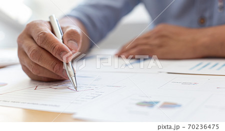 Businessmen analyze market data and calculate the cost of buying-selling products for a client's company, Professional marketing and financial accountants concept. 70236475