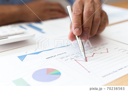 Businessmen analyze market data and calculate the cost of buying-selling products for a client's company, Professional marketing and financial accountants concept. 70236563