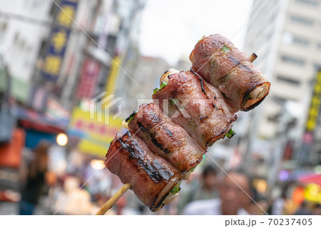 The close up of Taiwanese traditional barbecue (BBQ) food at night market background in Taiwan. The close up of Taiwanese traditional barbecue (BBQ) food at night market background in Taiwan. 70237405