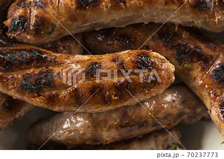 Sausages on barbecue grill background 70237773