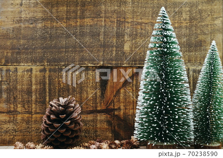 Christmas Festive background concept decoration with Christmas tree and pine cones on wooden background Christmas Festive background concept decoration with Christmas tree and pine cones on wooden background 70238590