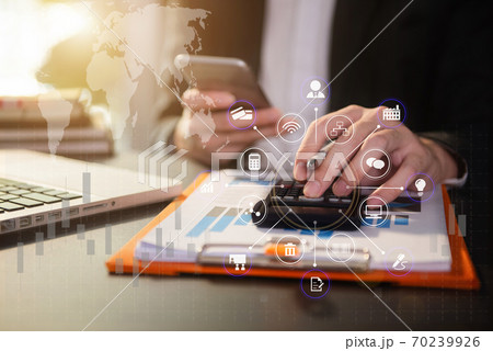 Male businessman working on desk office with using a calculator to calculate the numbers, finance accounting concept. 70239926