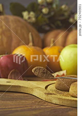 Cookies with pumpkins and apples on the table. 70240901