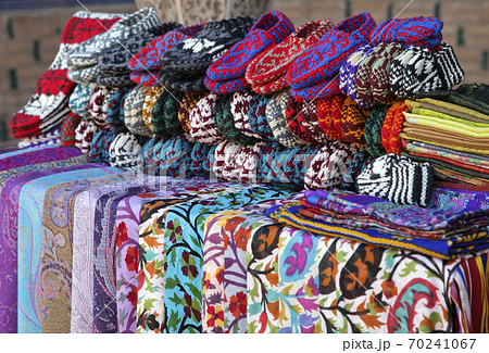 Scarves and knitted slippers in a street market, Uzbekistan 70241067