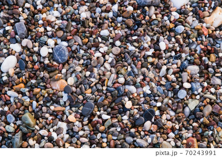 Background of colored sea pebbles on the beach of Alanya, Turkey. Seamless texture Background of colored sea pebbles on the beach of Alanya, Turkey. Seamless texture 70243991