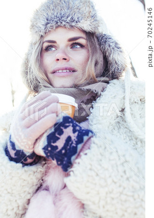young pretty teenage hipster girl outdoor in winter snow park having fun drinking coffee, warming up happy smiling, lifestyle people concept young pretty teenage hipster girl outdoor in winter snow park having fun drinking coffee, warming up happy smiling, lifestyle people concept 70245146