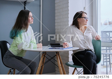 Woman social worker talking to teenage girl Woman social worker talking to teenage girl 70245776