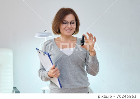 Beauty business, woman owner with clipboard and nail gel polish Beauty business, woman owner with clipboard and nail gel polish 70245863