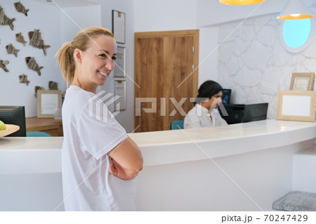 Portrait of spa hotel workers, woman near reception Portrait of spa hotel workers, woman near reception 70247429