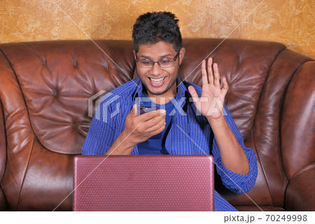 happy young man In a video conference discussing on smart phone  70249998