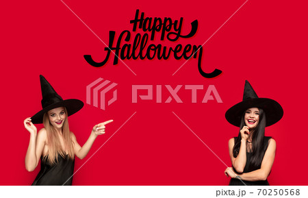 Young attrective women in hat as a witch on scary background Young attrective women in hat as a witch on scary background 70250568