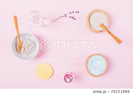 Flat lay cosmetic clay face mask with lavender aroma oil and water on pink background Flat lay cosmetic clay face mask with lavender aroma oil and water on pink background 70251066