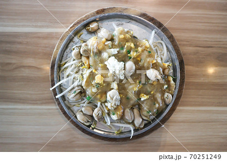 Oyster omelette or stir fried Oyster with egg and vegetable 70251249