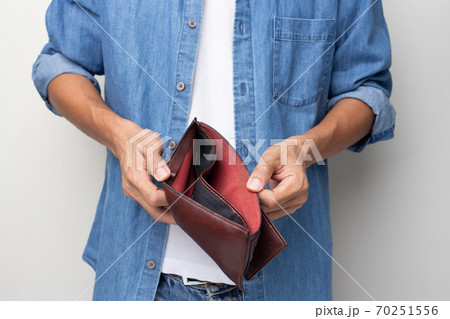Man hand holding empty wallet on white background Man hand holding empty wallet on white background 70251556