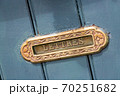 Vintage mailbox inlaid in a blue wooden door 70251682