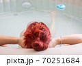 Pretty natural redheaded woman relaxing in her jacuzzi 70251684