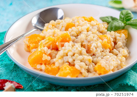 Homemade risotto with pumpkin and parmesan. 70251974