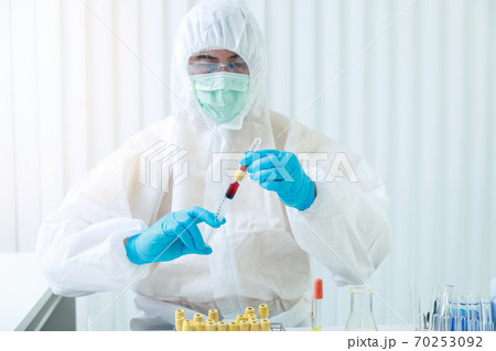 Researchers load blood samples of patients infected with the disease in the laboratory. 70253092