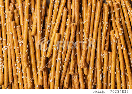 Salty sticks. Crunchy pretzels with sesame seeds. 70254835