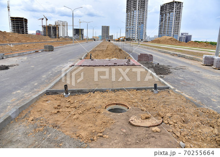 Laying paving slabs and borders at construction site. Laying paving slabs and borders at construction site. 70255664