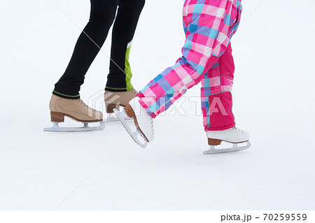 foot skating little girls and women on an ice rink foot skating little girls and women on an ice rink 70259559