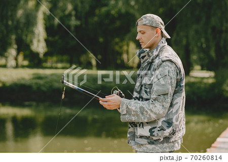 Man fishing and holds the angling rod Man fishing and holds the angling rod 70260814