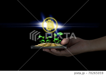 Human hand holding mobile smart phone with piles of golden coins and bitcoin symbol,Lucky economic growth concept Human hand holding mobile smart phone with piles of golden coins and bitcoin symbol,Lucky economic growth concept 70265059