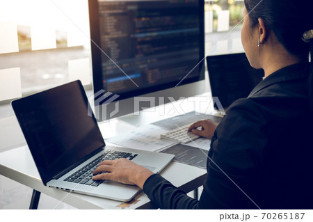 Developing programming and coding technologies working in a software engineers developing applications together in office. 70265187