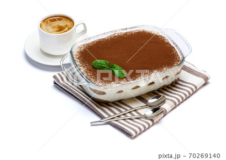 Traditional Italian Tiramisu dessert in glass baking dish and cup of fresh espresso coffee isolated on white background with clipping path 70269140