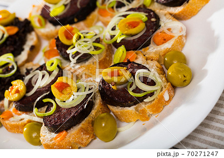 Canapes with blood sausage and olives Canapes with blood sausage and olives 70271247
