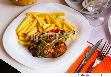 Delicious baked with vegetables pork with french fries Delicious baked with vegetables pork with french fries 70271677