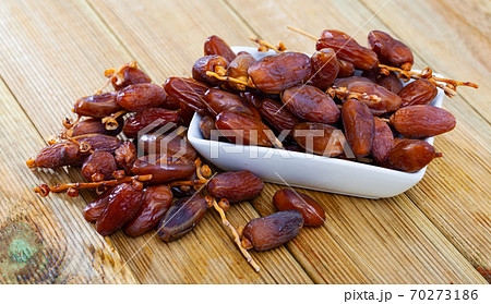 Fresh dates on wooden background, healthy snack 70273186