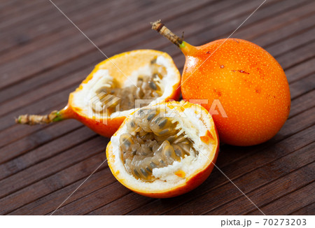 Granadilla fruit on wooden table closeup Granadilla fruit on wooden table closeup 70273203