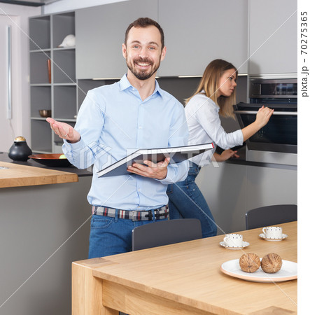 Man with book on background of girlfriend Man with book on background of girlfriend 70275365