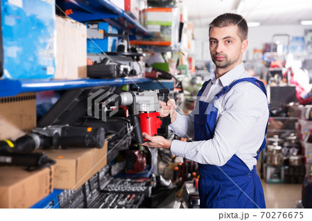 Man choosing drilling machine Man choosing drilling machine 70276675