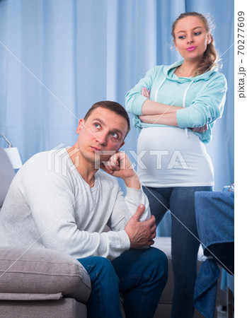 Husband and pregnant wife arguing at home Husband and pregnant wife arguing at home 70277609