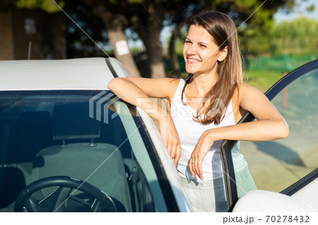 Portrait of driver caucasian woman next to car Portrait of driver caucasian woman next to car 70278432